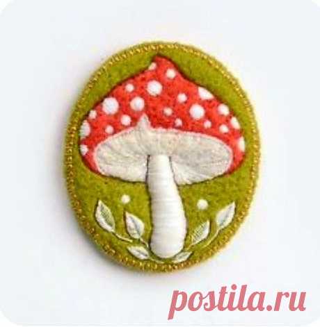 a green and white patch with a red mushroom on it