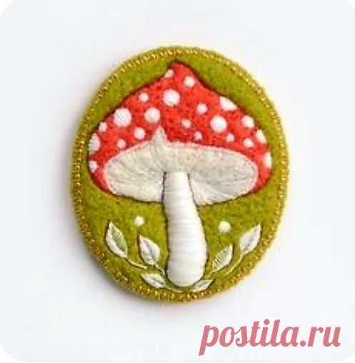 a green and white patch with a red mushroom on it