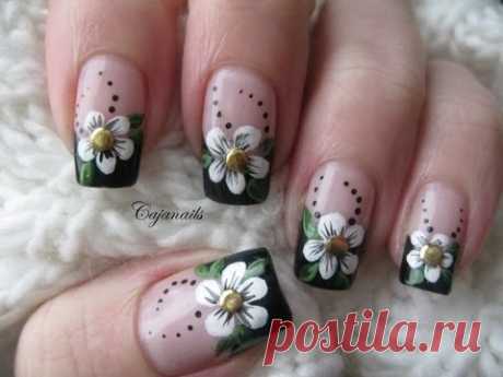 Nail art: Black french manicure with flower and studs
