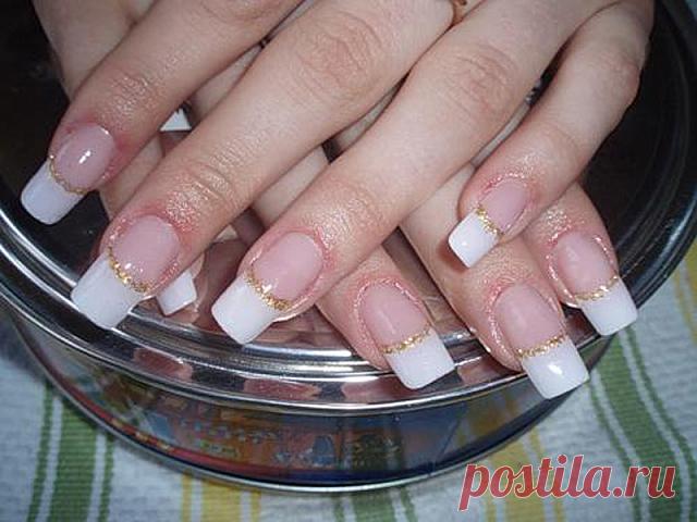 Wedding manicure with white nail polish at the free edge and gold nail polish like an ornament