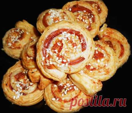 Простая и гениальная идея
Слоеное тесто разморозить, немного раскатать, выложить по всей площади тонкие ломтики ветчины, сверху сыр, по желанию, можно тесто смазать кетчупом . Свернуть в рулет, нарезать на бочоночки толщиной 2-3 см, сверху посыпать приправой( если любите) или кунжутом. Отправить в разогретую до 180-200 градусов духовку на 20-30 минут( смотрите по готовности)