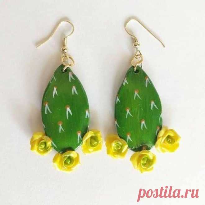 two green and yellow cactus earrings with flowers on the bottom one is dangling from gold plated earwires