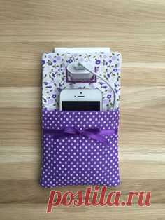 Phone charger holder / phone charging station a practical textile Pocket, this cell phone charging socket holder is the perfect solution for charging your smart phone at home and when you are traveling!  You can protect your Phone from being stepped on by using this unique handmade cell phone charging station pocket. When not in use store the phone charger is perfect.  Made with a cotton fabric, the back is made with felt, and a stiff interlining gives it strength.
