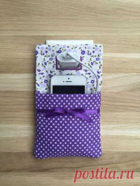 Phone charger holder / phone charging station a practical textile Pocket, this cell phone charging socket holder is the perfect solution for charging your smart phone at home and when you are traveling!  You can protect your Phone from being stepped on by using this unique handmade cell phone charging station pocket. When not in use store the phone charger is perfect.  Made with a cotton fabric, the back is made with felt, and a stiff interlining gives it strength.