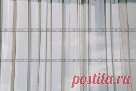 Window with light tulle curtains. Стоковое фото, фотограф Ilaronsia / Фотобанк Лори