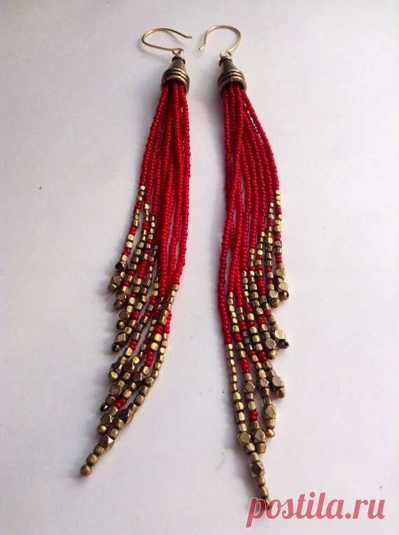 Beaded Shoulder Dusters. Native Inspired Bead Earrings. Gypsy Jewelry. Red and Gold Fringe Earrings. Tribal Jewelry ~ These long shoulder dusters, with wonderful movement, have 8 strands of tiny glass seed beads in a rich, deep red color paired 3 different types of faceted brass beads for accent. ~ The 8 strands are graduated, creating a fringe that moves like water ~ The cone from which these strands sprout is of the same brass as the accent beads     ~ 6-1/2 inches from ...
