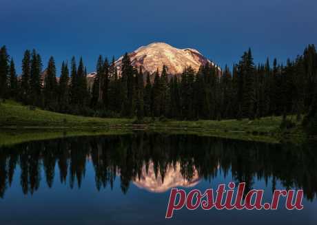 Glacial Glow And from the darkness a bright light shines forth.  Rainier's many glaciers capture the day's first light reflected in a calm Tipsoo Lake.   This is one of the most iconic and popular places for photographers in the Pacific NW.    "With 26 major glaciers and 36 sq mi of permanent snowfields and glaciers, Mount Rainier is the most heavily glaciated peak in the lower 48 states. The summit is topped by two volcanic craters, each more than 1,000 ft in diameter, wi...