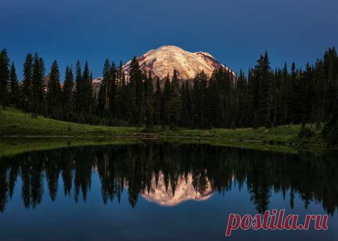 Glacial Glow And from the darkness a bright light shines forth.  Rainier's many glaciers capture the day's first light reflected in a calm Tipsoo Lake.   This is one of the most iconic and popular places for photographers in the Pacific NW.    