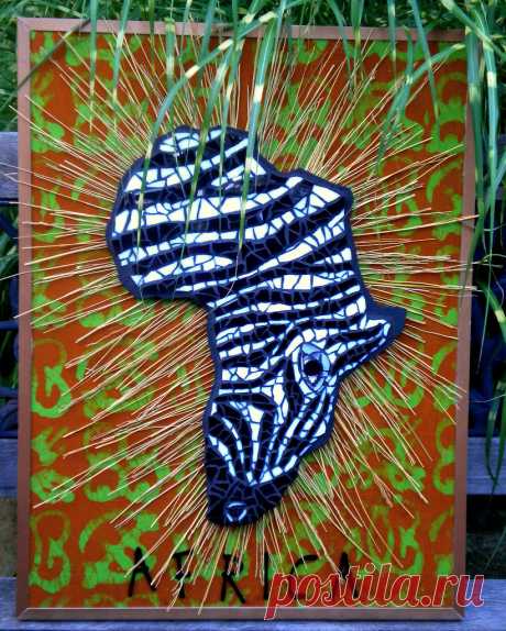 Mixed Media Zebra Challenge Entry Zebra Head is in the shape of the  Continent of Africa.  Fabric background is a batik from Africa which I purchased from Etsy and the letters were also purchased from etsy  The straw-like sunburst pattern behind the head was chosen to interpret  the dry african plains.