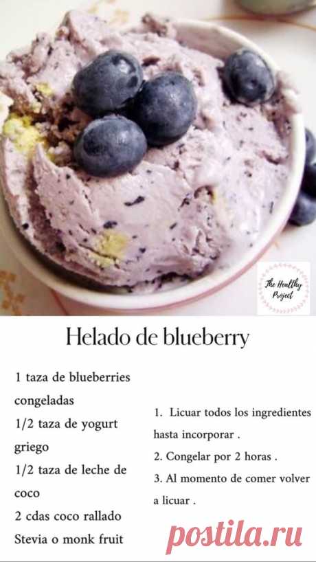 a bowl filled with ice cream and blueberries on top of a white tablecloth