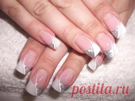 Wedding manicure with silver glittering nail polish .