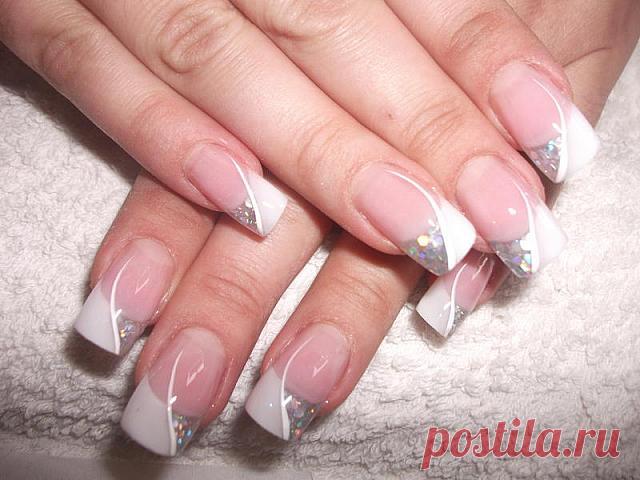 Wedding manicure with silver glittering nail polish .