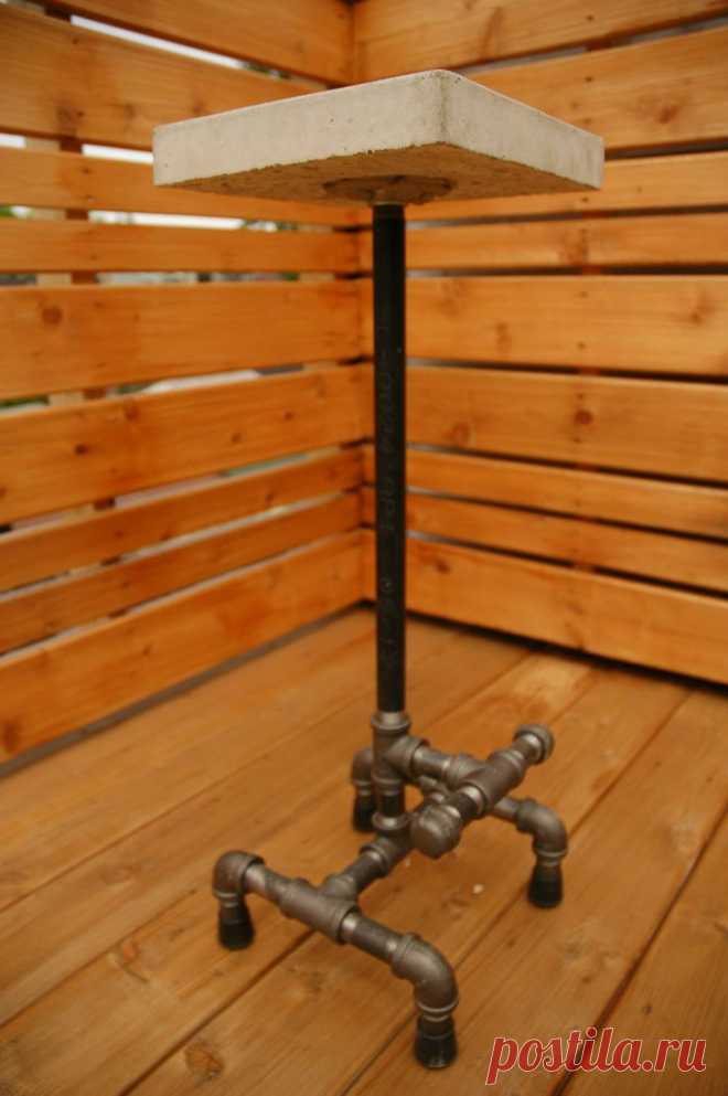 Poured concrete stool with 3/4 inch black steel piping base with footmounts…