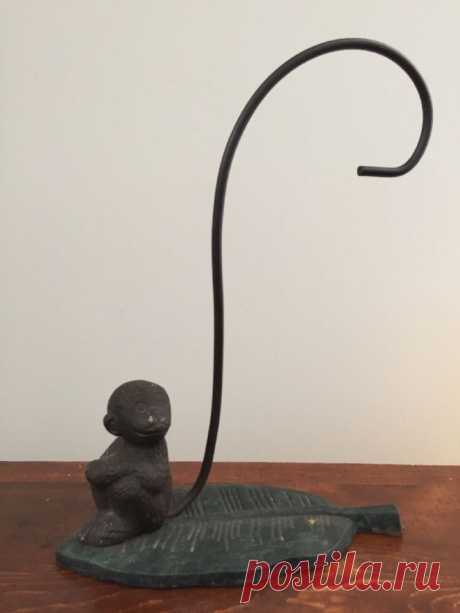 Vintage Cast Iron Monkey Banana Stand Holder  | eBay This adorable cast iron monkey is sitting on a banana leaf, and his long tail curls up, waiting to hold your bananas. Dimensions: 9 1/4" long x 4 1/4" x wide x 13 1/4" tall. Monkey is 3 3/4" tall. | eBay!