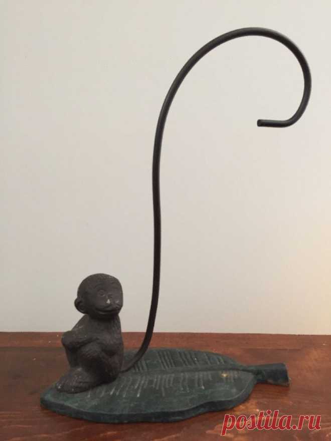Vintage Cast Iron Monkey Banana Stand Holder  | eBay This adorable cast iron monkey is sitting on a banana leaf, and his long tail curls up, waiting to hold your bananas. Dimensions: 9 1/4