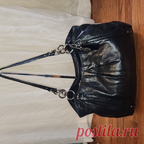 COACH Alexandra Black Leather Tote Shoulder Bag Shop eygibb's closet or find the perfect look from millions of stylists. Fast shipping and buyer protection. Beautiful black leather Coach bag!
Made in 2010 Style #16244

Silver chain and leather straps. Pleated details. Roomy interior features 3 separate compartments. Middle compartment zips closed. Other compartments contain 1 zip and 2 slip pockets
Blue satin lining. Snap closure at top of bag. Leather and signature C meta...