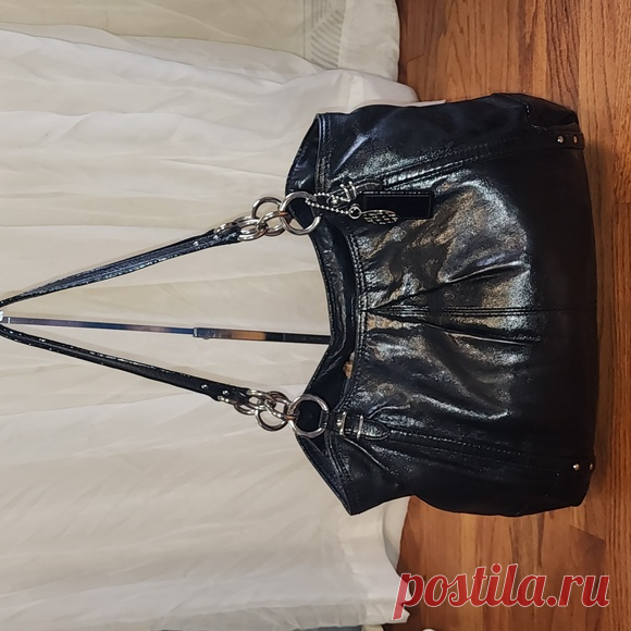 COACH Alexandra Black Leather Tote Shoulder Bag Shop eygibb's closet or find the perfect look from millions of stylists. Fast shipping and buyer protection. Beautiful black leather Coach bag!
Made in 2010 Style #16244

Silver chain and leather straps. Pleated details. Roomy interior features 3 separate compartments. Middle compartment zips closed. Other compartments contain 1 zip and 2 slip pockets
Blue satin lining. Snap closure at top of bag. Leather and signature C meta...