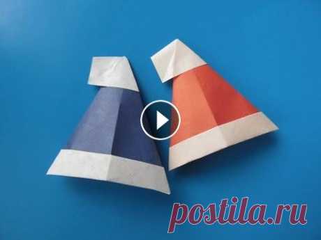 ШАПКА САНТЫ -   Легкое Новогоднее Оригами из Бумаги Своими Руками. Видео урок для детей и начинающих Из этого видео Вы узнаете, как легко своими руками сделать новогоднюю ШАПКУ САНТЫ из бумаги в стиле оригами. Вам понадобится квадратный листик. Размер...