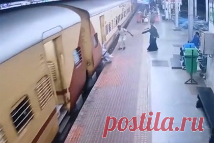 Полицейский спас упавшую с подножки движущегося поезда девушку и попал на видео