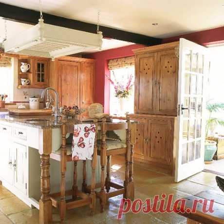 Kitchen with wooden and painted units, island and tiled floor | housetohome.co.uk
