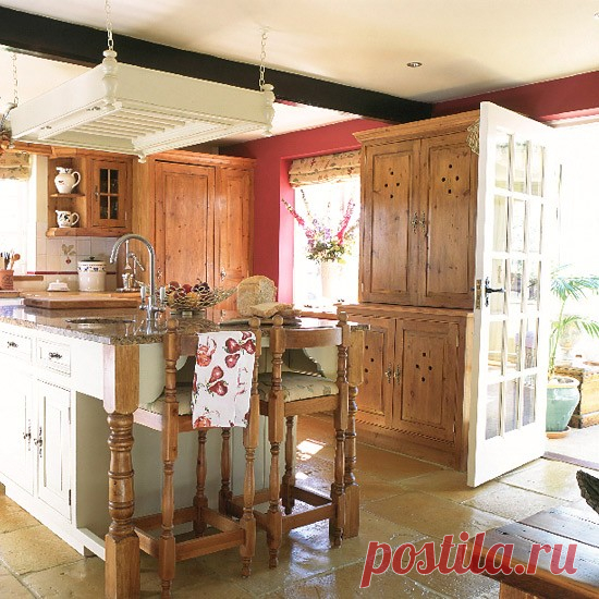 Kitchen with wooden and painted units, island and tiled floor | housetohome.co.uk