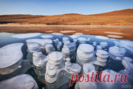 "Bubbles of frozen methane seen through crystal clear ice of" Lake Baikal in Russia. Photographer: Stas Tolstnev - 9GAG