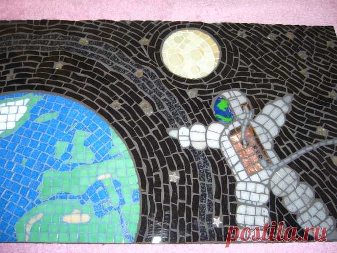 Spaceman Full view, made for Planet Earth exhibition. Materials include glass tiles, ceramic tiles, glass, metal stars, earth grouted in blue, moon grouted in yellow, rest is black.. Size18 1/2in  x11 1/2 in.