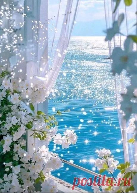 an open window overlooking the ocean with white flowers on it and water in the background