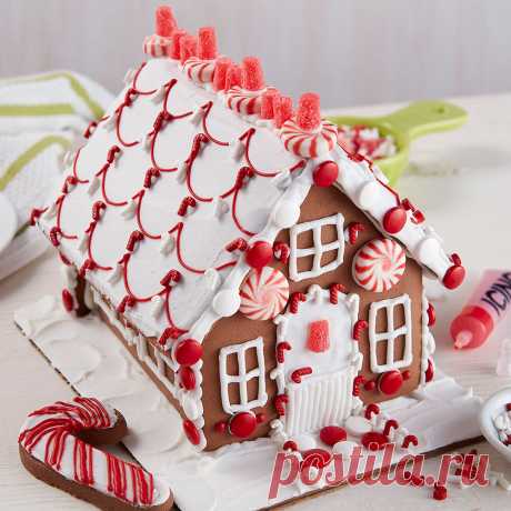 Designer Chocolate Cookie House #2 One look and you won’t be able to wait to decorate this chocolate cookie house, bright with visions of peppermint colors and candy.  Sharing the activity of decorating this house together makes the entire family merry!