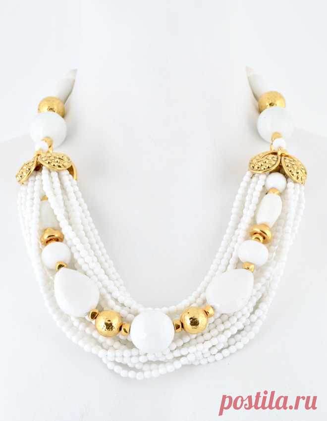 Thirteen strand faceted chalk white glass bead necklace featuring two 24 kt gold plated caps paved with gold plated Austrian crystals and accented with gold plated hammered brass beads, nuggets, and clasp. Measures  23.5 ” in length plus 3” chain extender .    Hand crafted in NYC    Items usually sh