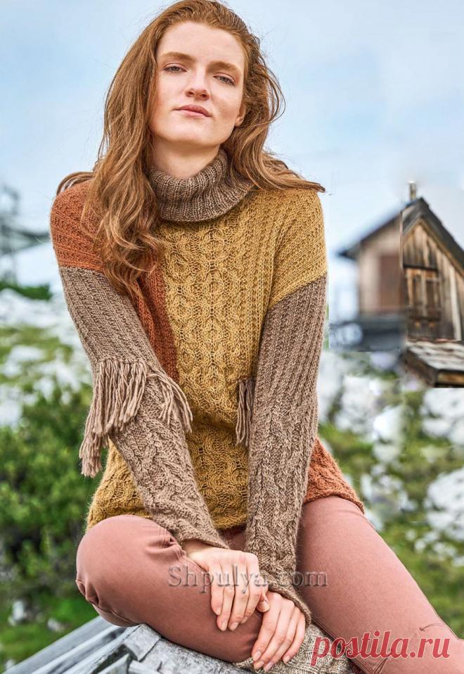 Красивый свитер с воротом гольф связан спицами сочетанием различных узоров из «Кос» и резинки из мягкой разноцветной пряжи природных оттенков и отделан бахромой.