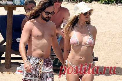 50-летняя Хайди Клум в купальнике попала в объектив папарацци. Немецкая супермодель Хайди Клум попала в объектив папарацци во время отдыха в Сардинии, Италия. 50-летнюю знаменитость запечатлели на пляже в компании супруга, гитариста рок-группы Tokio Hotel, Тома Каулитца. Так, манекенщица предстала перед камерами в раздельном купальнике пастельно-розового цвета.