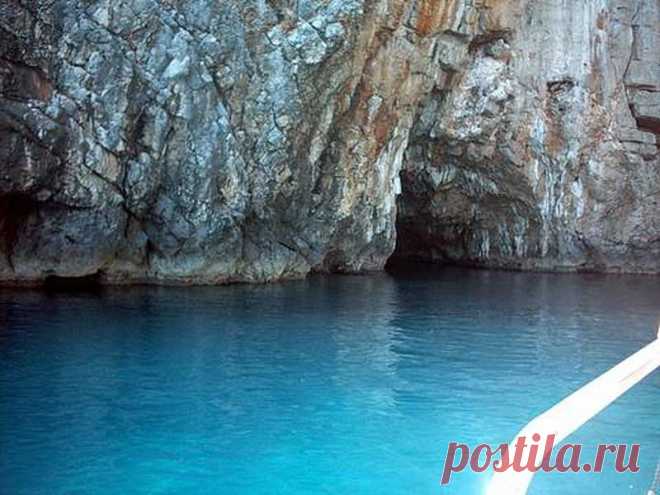(2) This is Montenegro
Plava Spilja (Blue Grotto) – Blue Cave

Imagine if you found a small boat on the side of a tranquil bay and the captain, after helping you on board, set sail up the coast for what only seemed like a 10 minute trip. You’re headed towards Plava Spilja, and the excitement takes hold of you. You’re expectations are running high, although after your short trip the captain suddenly steers the boat directly at a cliff of rough rocks.