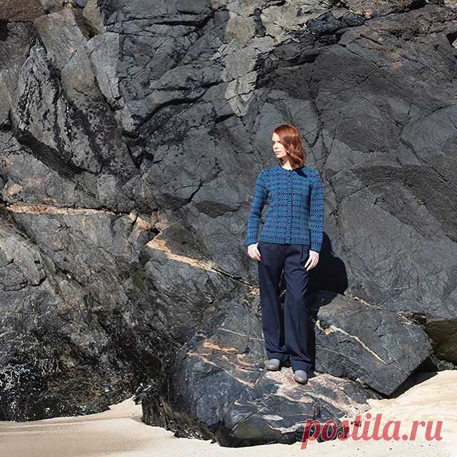 The fitted Selkie cardigan against shoreline textures and rocks