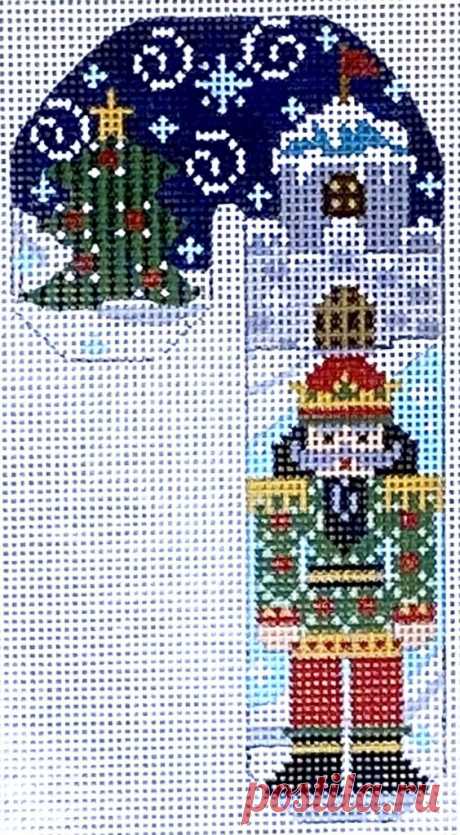 Green and Red Nutcracker Candy Cane This candy cane features a green and red nutcracker in front of a castle and Christmas tree. 5.25 x 3" on 18 mesh.