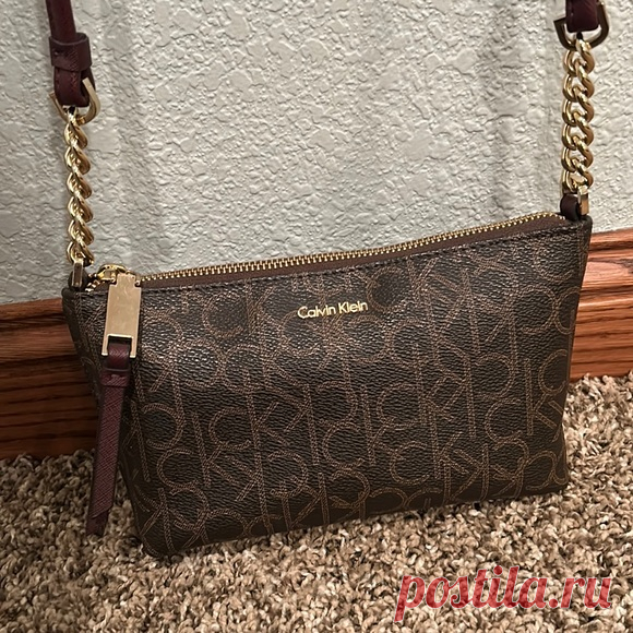 Calvin Klein Crossbody Purse Shop emmy_dockter's closet or find the perfect look from millions of stylists. Fast shipping and buyer protection. In excellent condition! $40

•Zipper across the top.
•Extra pocket(w/ zipper) on the inside for extra storage 
•Maroon colored shoulder strap
•Gold zipper & chains
•7 1/2 x 5 inches (size of the purse)
•Length of the whole purse (with shoulder strap) is 27 inches

Open to offers!
Thank you for viewing😊