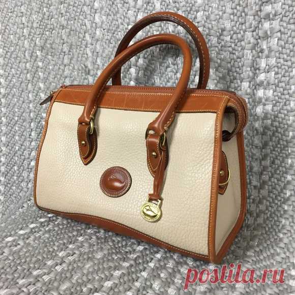 Vintage Dooney & Bourke White Satchel Purse Shop perennialwest's closet or find the perfect look from millions of stylists. Fast shipping and buyer protection. A great vintage Dooney & Bourke piece! This is a white color leather purse that features tan leather details. The interior is all leather lining with one zip pocket and one snap pocket. The exterior is in like new condition with a few light scratches along the top of the tan piece by the zipper but everything else i...