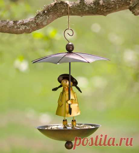 Handcrafted Metal Brolly Rain Girl Birdfeeder | Wind and Weather Forecast calling for rain No worries for hungry birds: this little weather girl holds her wide-top umbrella high over a deep basin to keep seed nice and dry. Under her charming slicker and boots are holes that drain unwanted moisture from the dish. Hangs from porch, tree limb or pole and becomes unsteady under the weight of squirrel's to deter them from eating from the feeder. Made of metal with a bright, ...