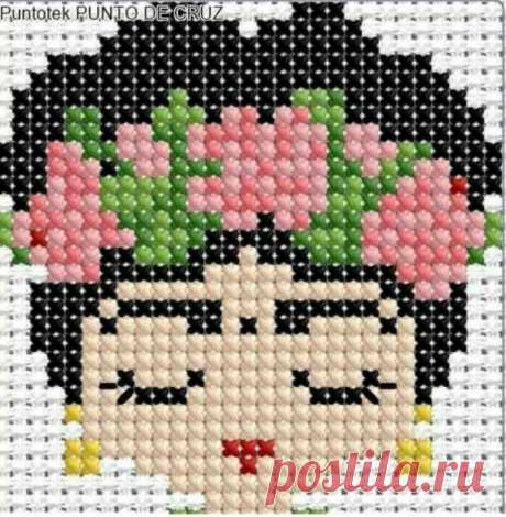 a cross stitched picture of a woman with flowers on her head and the words punto