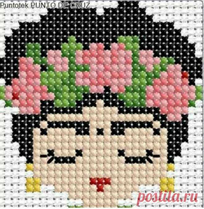 a cross stitched picture of a woman with flowers on her head and the words punto