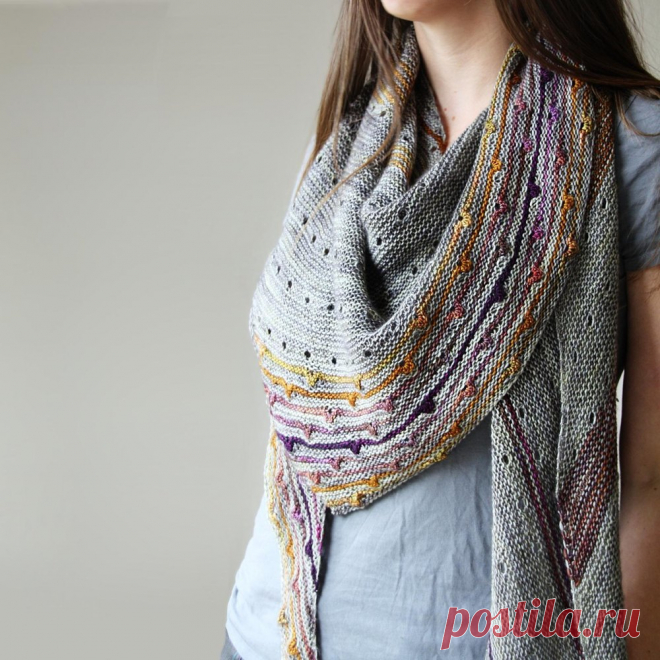 Solaris Knitting pattern by Melanie Berg Rainbows break through a cloud-gray background in Solaris, an asymmetrical triangle shawl drizzled with eyelet rows.Short row sections knit in a contrast color create smaller triangles inside the shawl, and the lower border is streaked with stripes and bobbles.The yarn is Tosh Merino Light by Madelinetosh, a stoney gray for the main body with the subtle rainbows of Unicorn Tails as the accent.