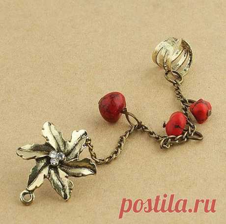 Серьга-пуссета Цветок с цепочкой, на которую нанизаны прозрачные бусины. Конец цепочки крепится манжетой (без прокола) на верх ушной раковины.