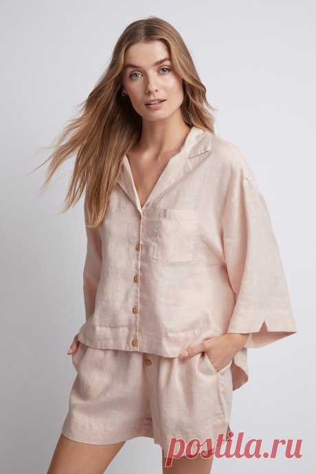 Riviera Linen PJ Set - Blush Beloved by influencers and the street style set, our 100% French stonewash linen Riviera matching pj set with wooden buttons is casually chic and ultra-comfortable. Designed to keep you cool whether you’re in the bedroom, at breakfast with friends, or at the beach, this gorgeous sustainable pj set is a sleepwear and lo