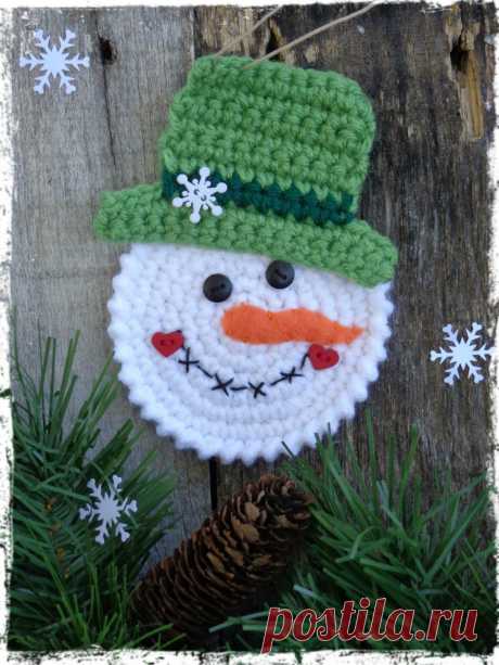 Who wouldnt love this adorable little snowman? Tie this sweet little man on a package for family and friends. Every year they will hang it on their Christmas tree and remember you! Snowman was crocheted with white yarn and a green top hat. His hand-stitched face is embellished with