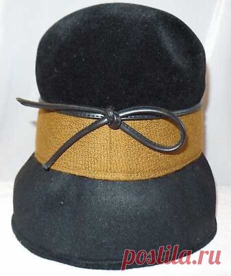 Vintage Jan Leslie Custom Design Wool Bucket Hat With Faux Leather Bow & Trim  | eBay Okay this is a pretty neat hat. I took pictures with an with out flash. It is a black wool hat and has a brown trim with a black faux leather bow. The bow is located at the back of the hat with the Jan Leslie Custom Design Label.