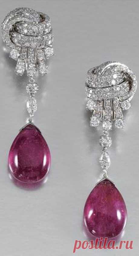 PAIR OF PENDENT RUBELLITE AND DIAMOND EARRINGS Each suspending a cabochon rubellite drop from a marquise-shaped diamond, to a stylised knot surmount set with brilliant-cut stones, post and clip fittings.