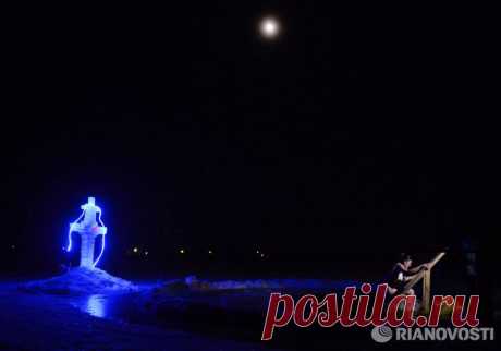 Epiphany Bathing in 2014/The water is blessed by the priests before the bathing.
Photo by Konstantin Chalabov. RIA Novosti