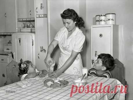 Drink Up: 1942 June 1942. "Brooklyn, New York. Red Hook housing development. Mrs. James Caputo in the modern kitchen of her apartment, pouring milk for Annette and Jimmy. The children drink more than a quart apiece daily." Acetate negative by Arthur Rothstein.