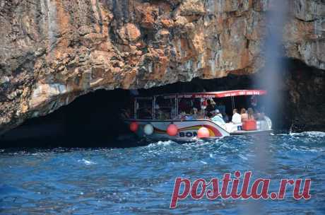 (2) This is Montenegro
Plava Spilja (Blue Grotto) – Blue Cave

Imagine if you found a small boat on the side of a tranquil bay and the captain, after helping you on board, set sail up the coast for what only seemed like a 10 minute trip. You’re headed towards Plava Spilja, and the excitement takes hold of you. You’re expectations are running high, although after your short trip the captain suddenly steers the boat directly at a cliff of rough rocks.