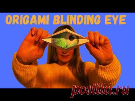 Оригами моргающий глаз из бумаги.